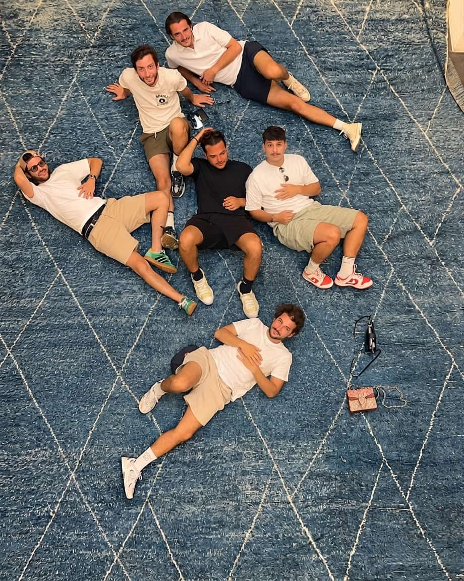 A group of friends celebrating together on a hand-knotted indigo Beni Ourain rug at Soufiane Zarib, Marrakech